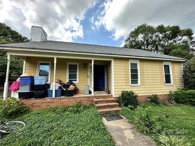 3396 Farm Lake Dr SW, Concord, NC 28027 - view of front facade with a porch, a chimney, and a shingled roof