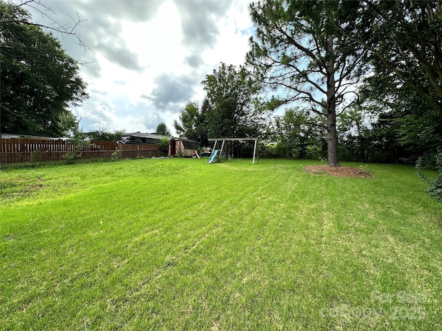 3396 Farm Lake Dr SW, Concord, NC 28027 - view of yard with a playground and a storage shed