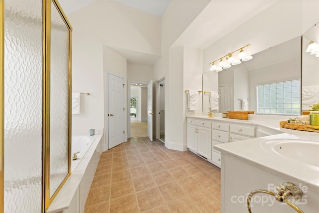 2241 Flagstick Dr, Matthews, NC 28104 - bathroom featuring double vanity, a garden tub, healthy amount of natural light, and a shower stall