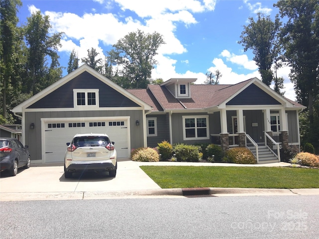 156 Olivet Ln, Fletcher, NC 28732 - craftsman house with board and batten siding, concrete driveway, an attached garage, a front yard, and a porch
