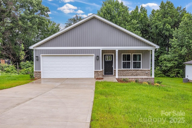 5185 Grand Canyon Rd, Concord, NC 28027 - view of front facade with a porch, a front yard, concrete driveway, and brick siding