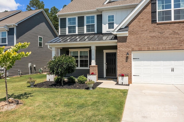 169 Rooster Tail Ln, Troutman, NC 28166 - craftsman-style house with a standing seam roof, a front lawn, a shingled roof, and brick siding