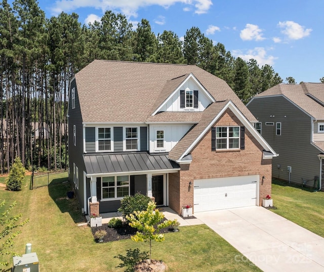 169 Rooster Tail Ln, Troutman, NC 28166 - view of front of house featuring brick siding, an attached garage, roof with shingles, concrete driveway, and a standing seam roof