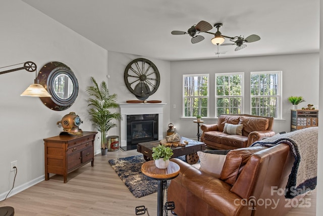 169 Rooster Tail Ln, Troutman, NC 28166 - living area with ceiling fan, light wood-type flooring, and a glass covered fireplace