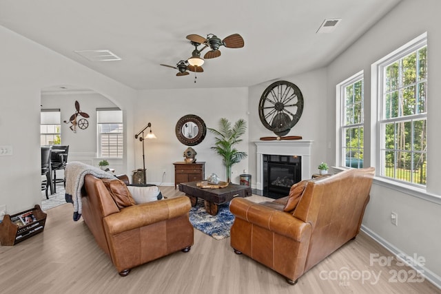 169 Rooster Tail Ln, Troutman, NC 28166 - living room with wood finished floors, ceiling fan, arched walkways, and healthy amount of natural light