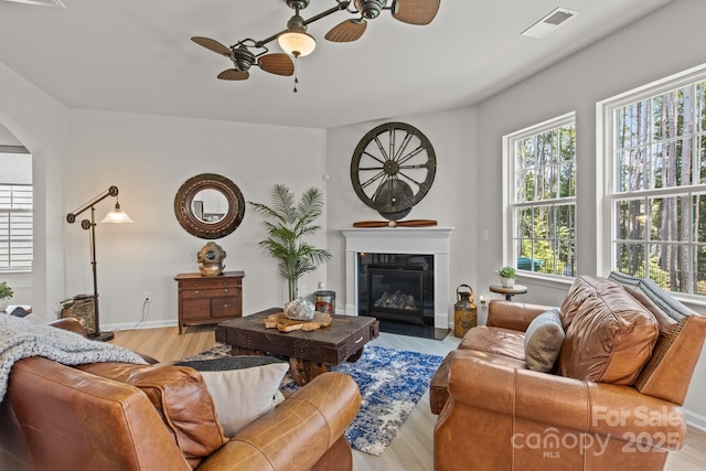 169 Rooster Tail Ln, Troutman, NC 28166 - living room with a ceiling fan, plenty of natural light, arched walkways, and a fireplace with flush hearth