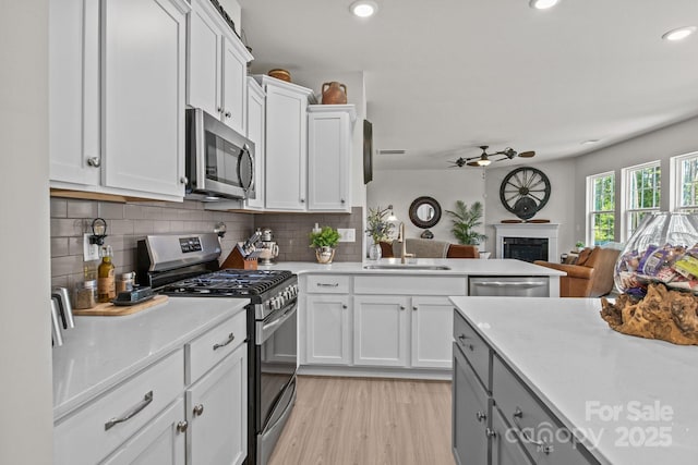169 Rooster Tail Ln, Troutman, NC 28166 - kitchen with appliances with stainless steel finishes, ceiling fan, light countertops, backsplash, and recessed lighting