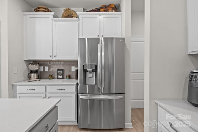169 Rooster Tail Ln, Troutman, NC 28166 - kitchen featuring stainless steel fridge with ice dispenser, tasteful backsplash, and white cabinets
