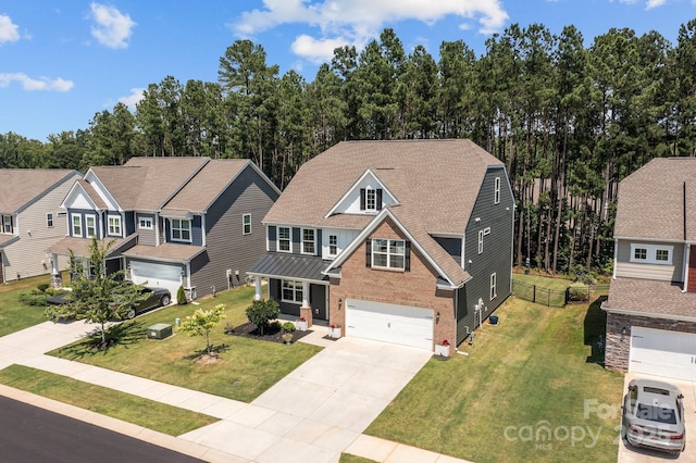 169 Rooster Tail Ln, Troutman, NC 28166 - view of front of house with driveway, an attached garage, brick siding, and roof with shingles