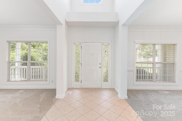 14333 Maclauren Ln, Huntersville, NC 28078 - foyer entrance featuring light carpet, light tile patterned floors, plenty of natural light, ornamental molding, and a high ceiling