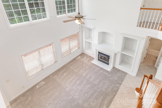 14333 Maclauren Ln, Huntersville, NC 28078 - unfurnished living room with built in features, healthy amount of natural light, a premium fireplace, and ceiling fan