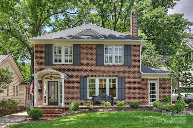 726 E Kingston Ave, Charlotte, NC 28203 - view of front of property with a chimney, brick siding, and roof with shingles