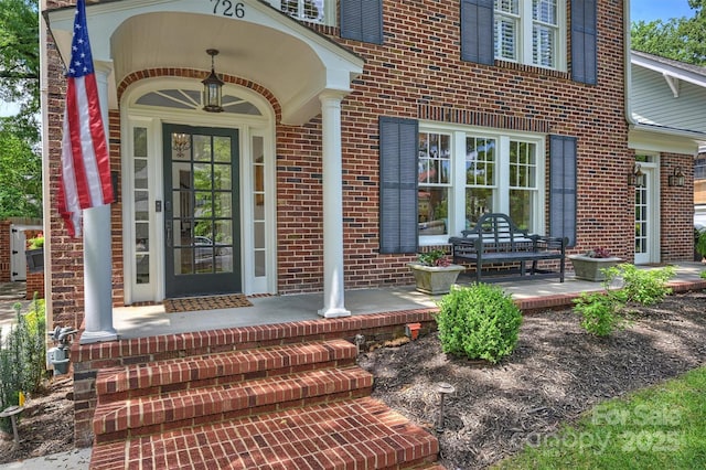 726 E Kingston Ave, Charlotte, NC 28203 - doorway to property featuring brick siding and a porch