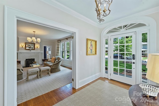 726 E Kingston Ave, Charlotte, NC 28203 - doorway featuring a chandelier, crown molding, wood finished floors, and a fireplace