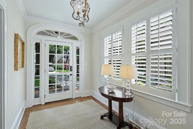726 E Kingston Ave, Charlotte, NC 28203 - entryway featuring plenty of natural light, wood finished floors, ornamental molding, and a chandelier