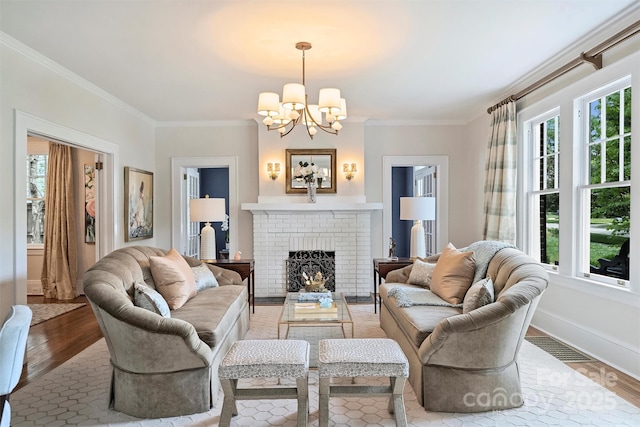 726 E Kingston Ave, Charlotte, NC 28203 - living area with a chandelier, crown molding, a brick fireplace, and light wood-style flooring