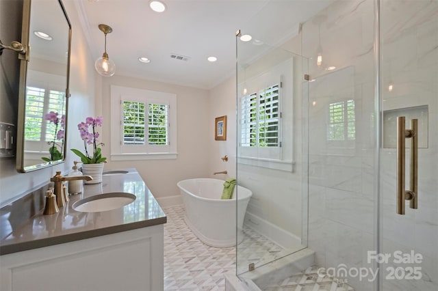 726 E Kingston Ave, Charlotte, NC 28203 - bathroom with double vanity, a stall shower, a freestanding bath, crown molding, and recessed lighting