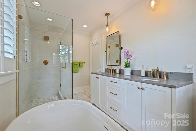 726 E Kingston Ave, Charlotte, NC 28203 - bathroom with a stall shower, double vanity, ornamental molding, a freestanding bath, and recessed lighting