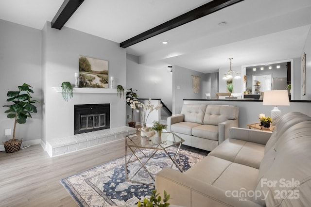 5192 Corbin Ln, Hickory, NC 28601 - living room with beamed ceiling, wood finished floors, a brick fireplace, a chandelier, and recessed lighting