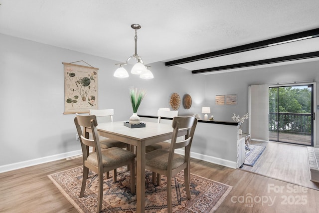 5192 Corbin Ln, Hickory, NC 28601 - dining space with beam ceiling, wood finished floors, and a chandelier