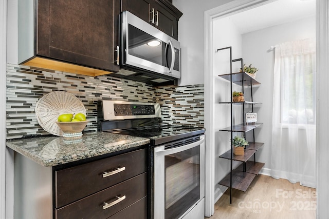 5192 Corbin Ln, Hickory, NC 28601 - kitchen with appliances with stainless steel finishes, dark brown cabinets, stone countertops, light wood-style flooring, and backsplash