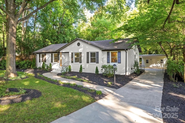 3519 Campbell Dr, Charlotte, NC 28205 - single story home featuring concrete driveway, stucco siding, a shingled roof, and an attached carport