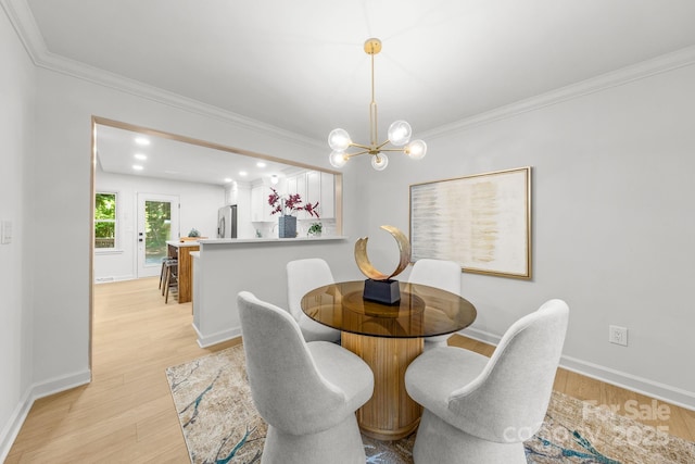 3519 Campbell Dr, Charlotte, NC 28205 - dining space featuring light wood-type flooring, ornamental molding, and a chandelier