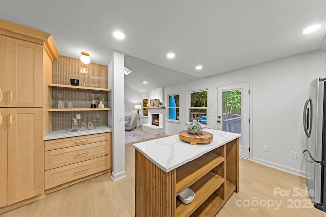 3519 Campbell Dr, Charlotte, NC 28205 - kitchen with open shelves, freestanding refrigerator, light brown cabinets, a lit fireplace, and recessed lighting