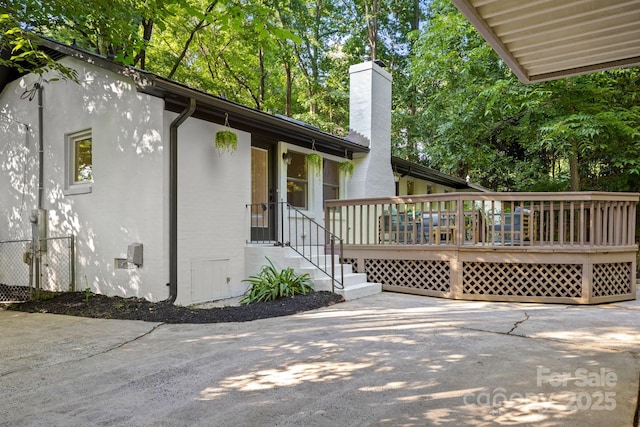 3519 Campbell Dr, Charlotte, NC 28205 - view of side of home featuring a chimney, a deck, and stucco siding