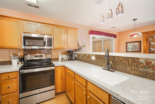 220 Holmes Ct, Concord, NC 28027 - kitchen with appliances with stainless steel finishes, tasteful backsplash, pendant lighting, light stone counters, and light wood-style floors