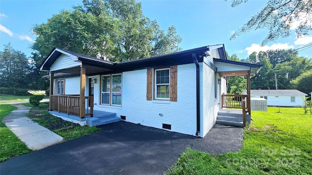 703 Central Dr NW, Concord, NC 28027 - view of front of house with crawl space, a front yard, and a porch