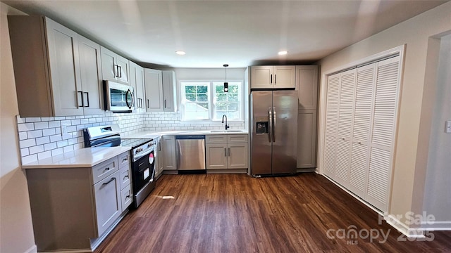 703 Central Dr NW, Concord, NC 28027 - kitchen with appliances with stainless steel finishes, dark wood-style flooring, light countertops, backsplash, and recessed lighting