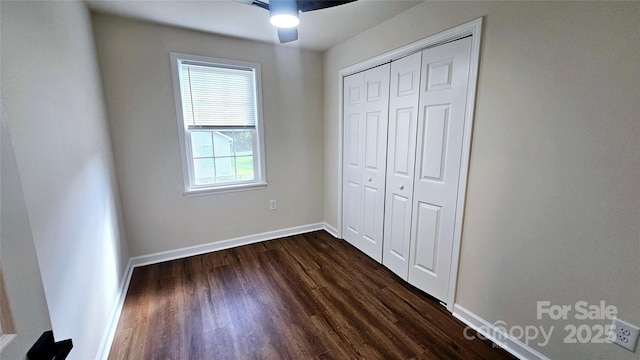 703 Central Dr NW, Concord, NC 28027 - unfurnished bedroom featuring dark wood finished floors, a closet, and ceiling fan