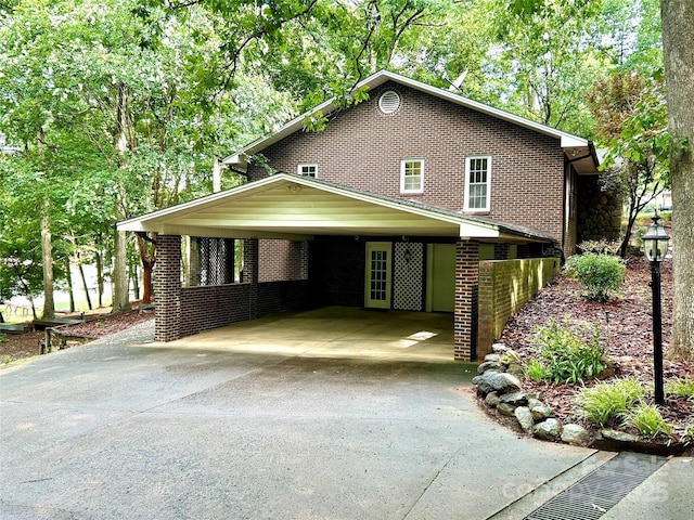 143 Uwharrie Ct Unit 1080, 1081, Mount Gilead, NC 27306 - view of front of home featuring driveway, a carport, and brick siding