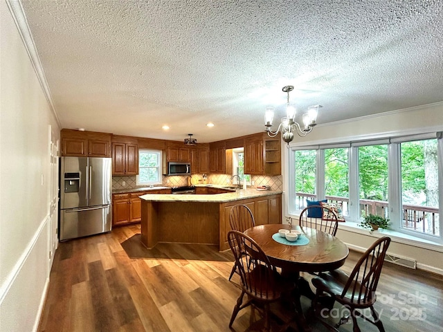 143 Uwharrie Ct Unit 1080, 1081, Mount Gilead, NC 27306 - dining space with a textured ceiling, a chandelier, wood finished floors, ornamental molding, and recessed lighting
