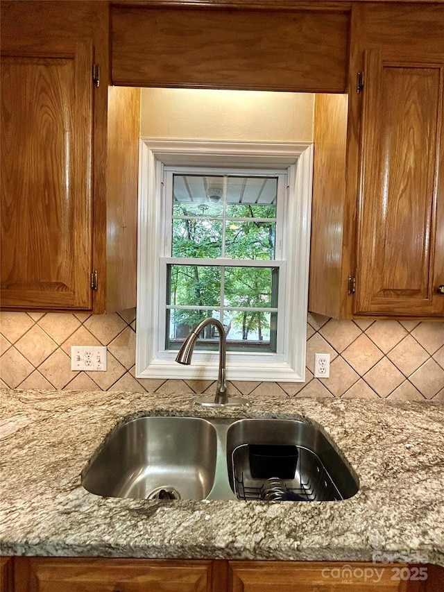 143 Uwharrie Ct Unit 1080, 1081, Mount Gilead, NC 27306 - kitchen view of brown cabinets, tasteful backsplash, and light stone countertops