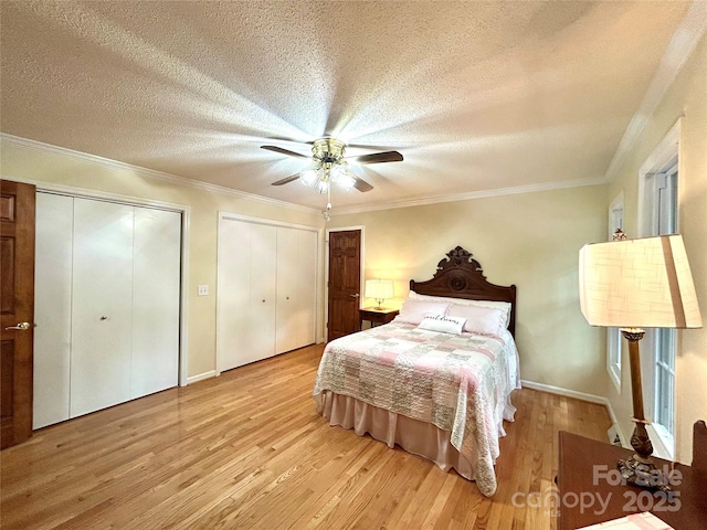143 Uwharrie Ct Unit 1080, 1081, Mount Gilead, NC 27306 - bedroom with wood finished floors, two closets, a textured ceiling, a ceiling fan, and crown molding