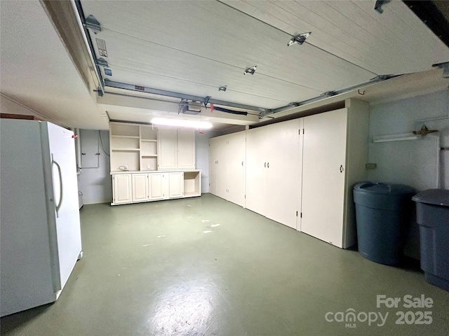 143 Uwharrie Ct Unit 1080, 1081, Mount Gilead, NC 27306 - garage featuring freestanding refrigerator and a garage door opener