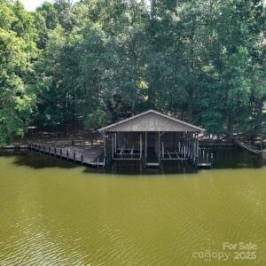 143 Uwharrie Ct Unit 1080, 1081, Mount Gilead, NC 27306 - dock with a water view and a wooded view