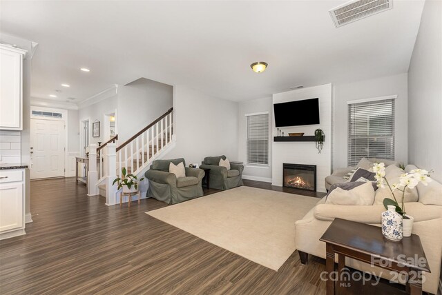 3332 Katherine Taylor Ct, Monroe, NC 28110 - living room featuring stairs, dark wood-style floors, a large fireplace, and recessed lighting