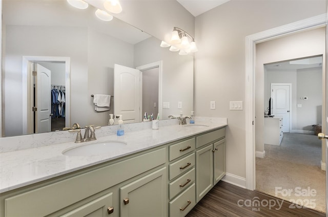 3332 Katherine Taylor Ct, Monroe, NC 28110 - bathroom with double vanity, a walk in closet, and wood finished floors