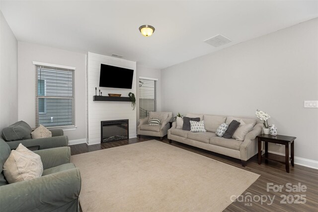 3332 Katherine Taylor Ct, Monroe, NC 28110 - living area featuring dark wood finished floors and a fireplace