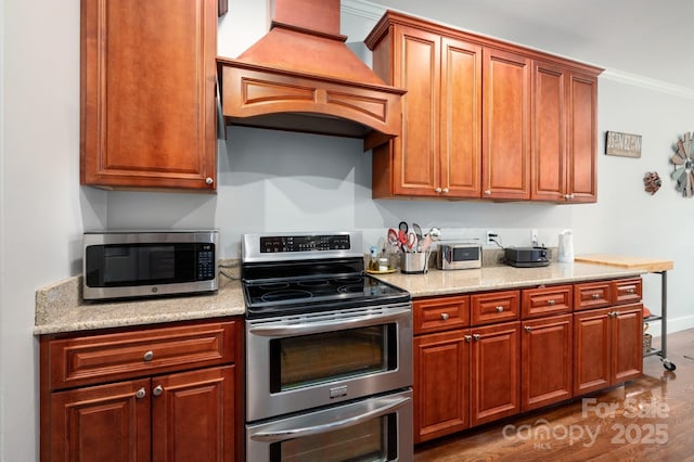 59 Ledgestone Dr, Fairview, NC 28730 - kitchen with appliances with stainless steel finishes, custom exhaust hood, dark wood-style flooring, crown molding, and brown cabinets