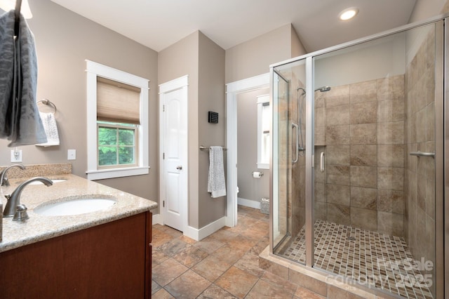 59 Ledgestone Dr, Fairview, NC 28730 - bathroom with double vanity, a stall shower, stone finish floors, and recessed lighting