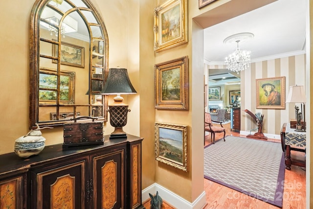 229 N Church St Unit 401, Charlotte, NC 28202 - hall featuring ornamental molding, a chandelier, and wood finished floors