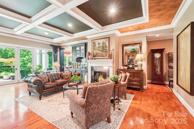 229 N Church St Unit 401, Charlotte, NC 28202 - living room with ornamental molding, a fireplace, wood finished floors, beam ceiling, and coffered ceiling