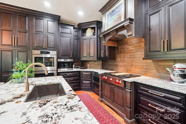 229 N Church St Unit 401, Charlotte, NC 28202 - kitchen featuring stainless steel appliances, light stone counters, decorative backsplash, dark brown cabinets, and recessed lighting