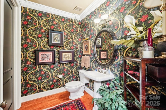 229 N Church St Unit 401, Charlotte, NC 28202 - half bathroom with wallpapered walls, ornamental molding, and wood finished floors