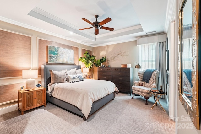 229 N Church St Unit 401, Charlotte, NC 28202 - bedroom featuring a tray ceiling, crown molding, light carpet, and ceiling fan