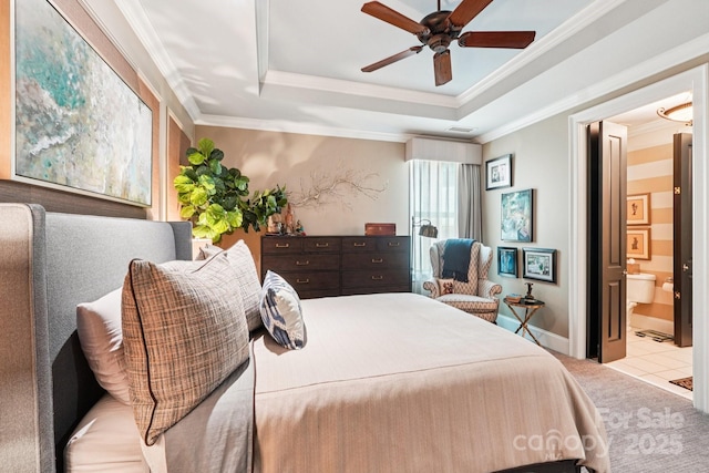 229 N Church St Unit 401, Charlotte, NC 28202 - bedroom featuring carpet flooring, a tray ceiling, ornamental molding, connected bathroom, and ceiling fan